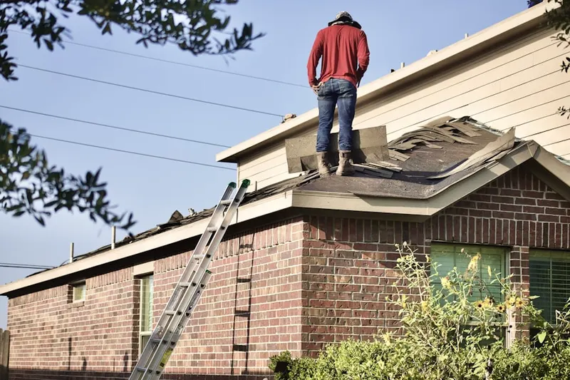 Professional roofer working on a residential roof in Ennis